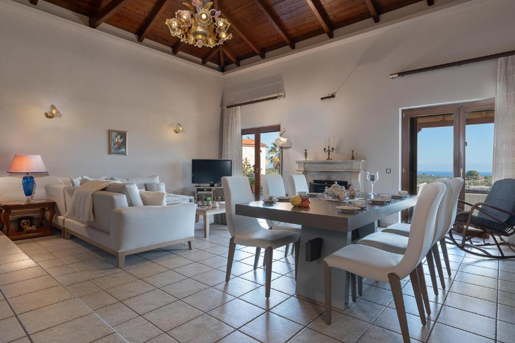 a living room with a table and chairs and a couch at Amara Haven in Aígio