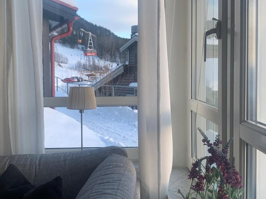 a living room with a window looking out at a ski lift at Perfect location ski-in Åre in Åre