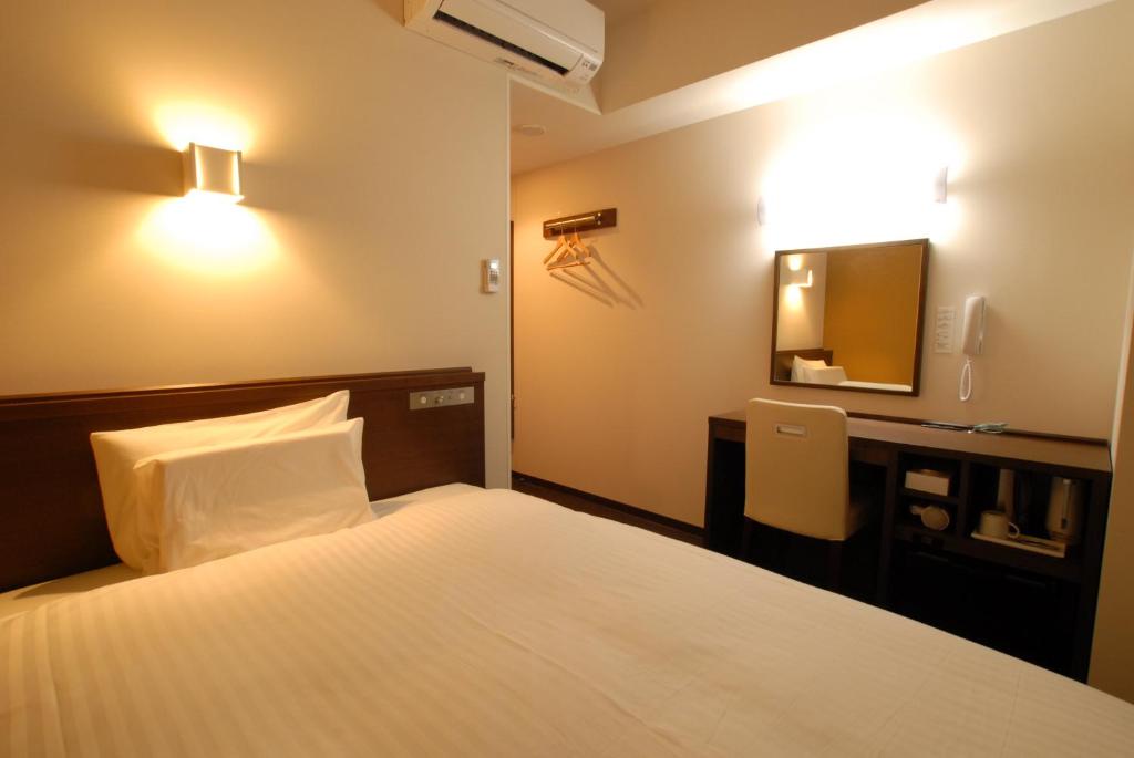 Postel nebo postele na pokoji v ubytování AB Hotel Kanazawa