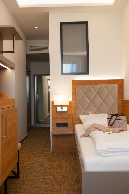 Postel nebo postele na pokoji v ubytování Hotel Ross
