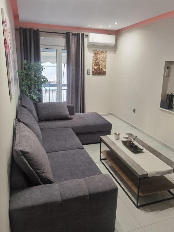 a living room with a couch and a coffee table at 70m 2BR bright luxury apt in Athens