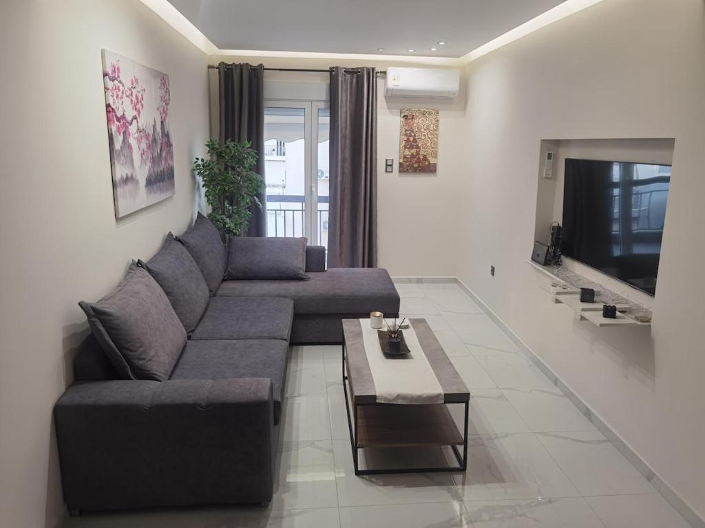 a living room with a couch and a coffee table at 70m 2BR bright luxury apt in Athens