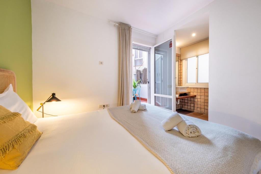 Posteľ alebo postele v izbe v ubytovaní Caliu Apartments Barcelona - Fira
