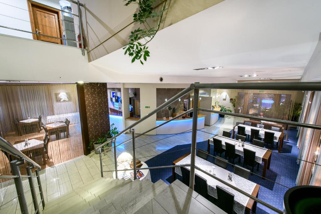 a view of a restaurant with tables and chairs at Hotel Nowy Dwór in Trzebnica