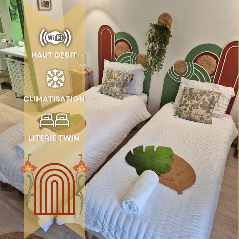 - 2 lits jumeaux dans une chambre avec un arc-en-ciel dans l'établissement Boudoir - Clim-Wifi-Twin-Gare, à Lourdes