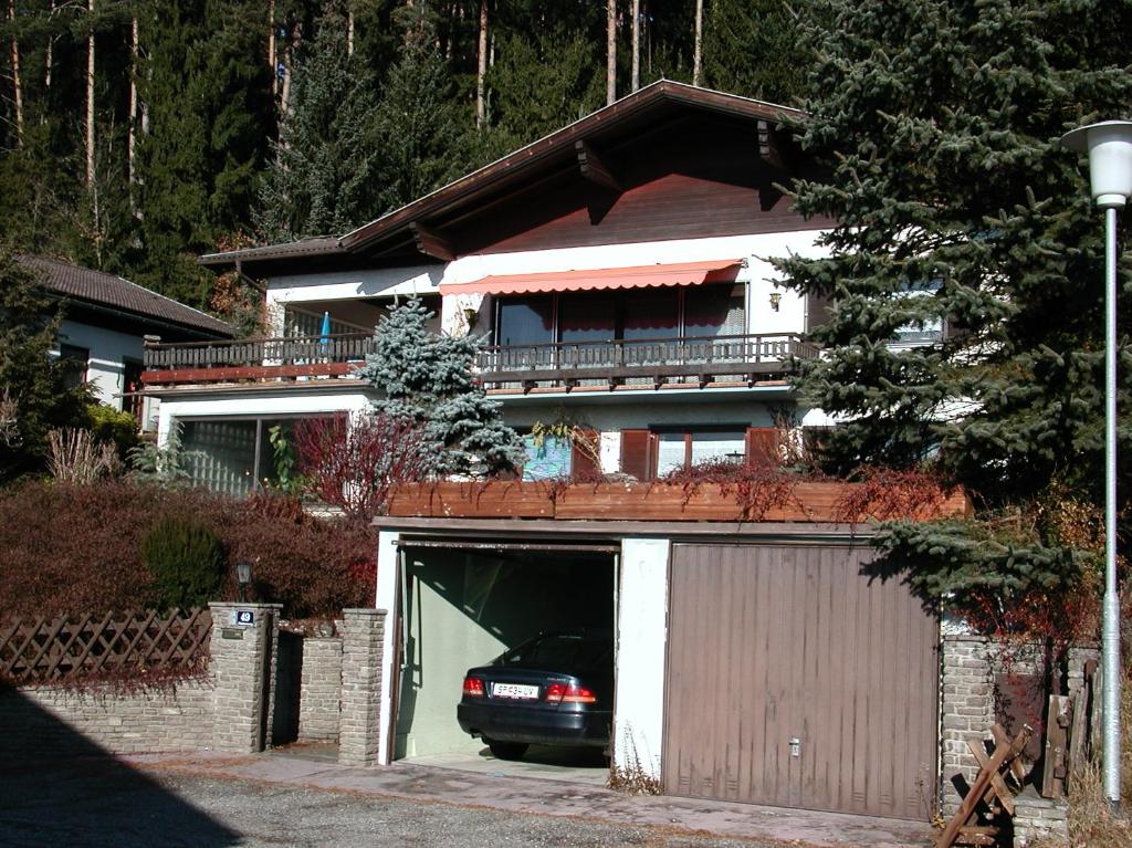 a house with a car in a garage at Pension Krüger in Seeboden