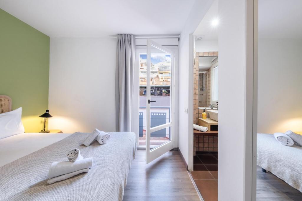 Posteľ alebo postele v izbe v ubytovaní Caliu Apartments Barcelona - Fira