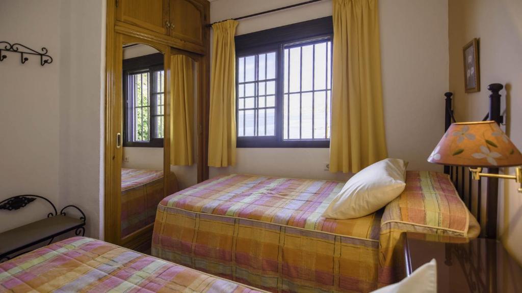 A bed or beds in a room at Villa Maro Casitas Select