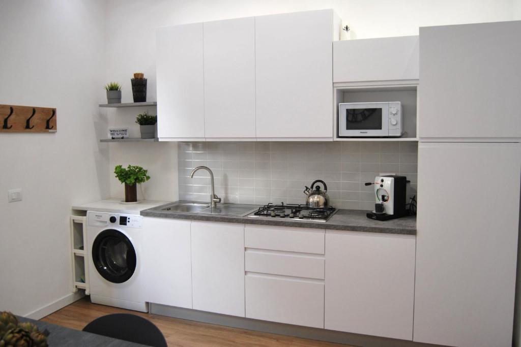 A kitchen or kitchenette at Rosato Suites 2 - Appartamento moderno e confortevole con spazio esterno tra Mondello e il centro storico