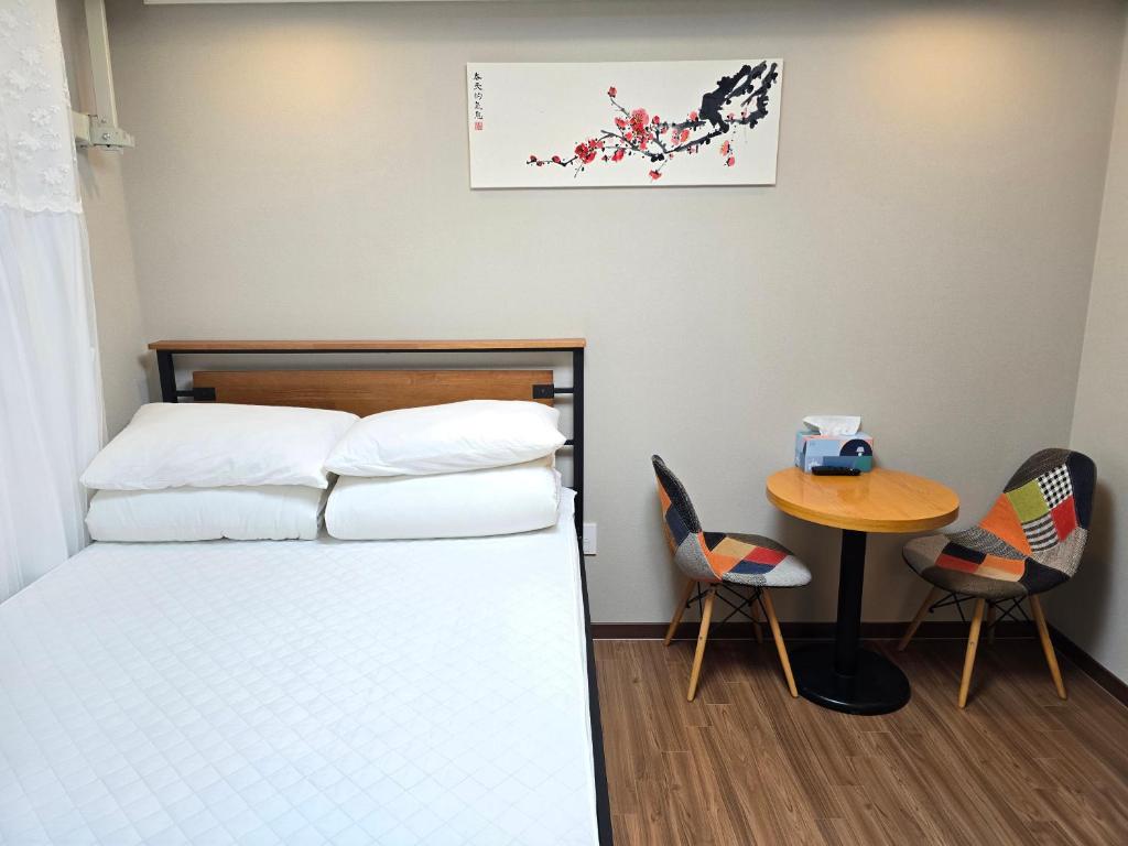 Postel nebo postele na pokoji v ubytování Incheon airport Guesthouse L