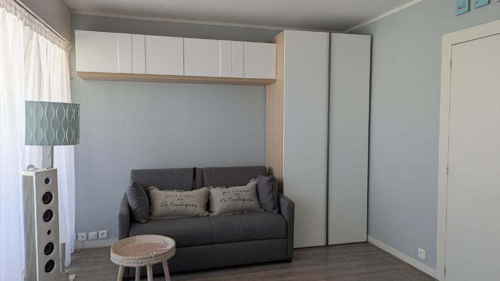 un salon avec un canapé et une table dans l'établissement Le Pouliguen - T1 bis - 5mn à pied de la plage - linge non fourni, au Pouliguen