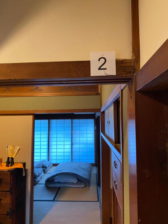 Postel nebo postele na pokoji v ubytování KUMANO家-OHGi-