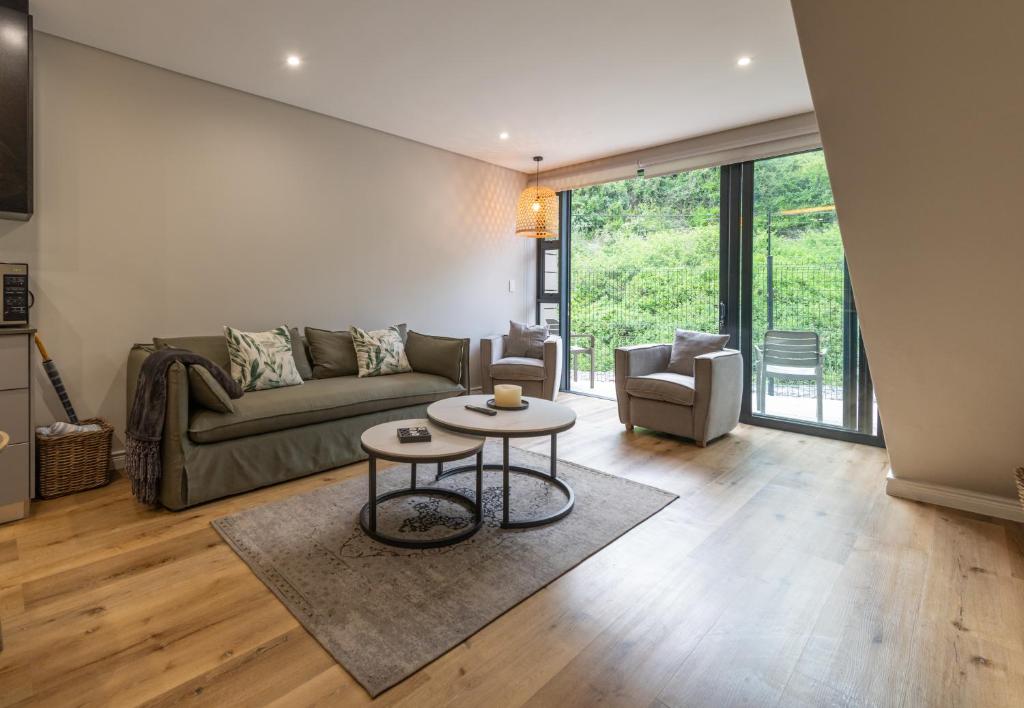 a living room with a couch and a table at The Ironwood in Wilderness