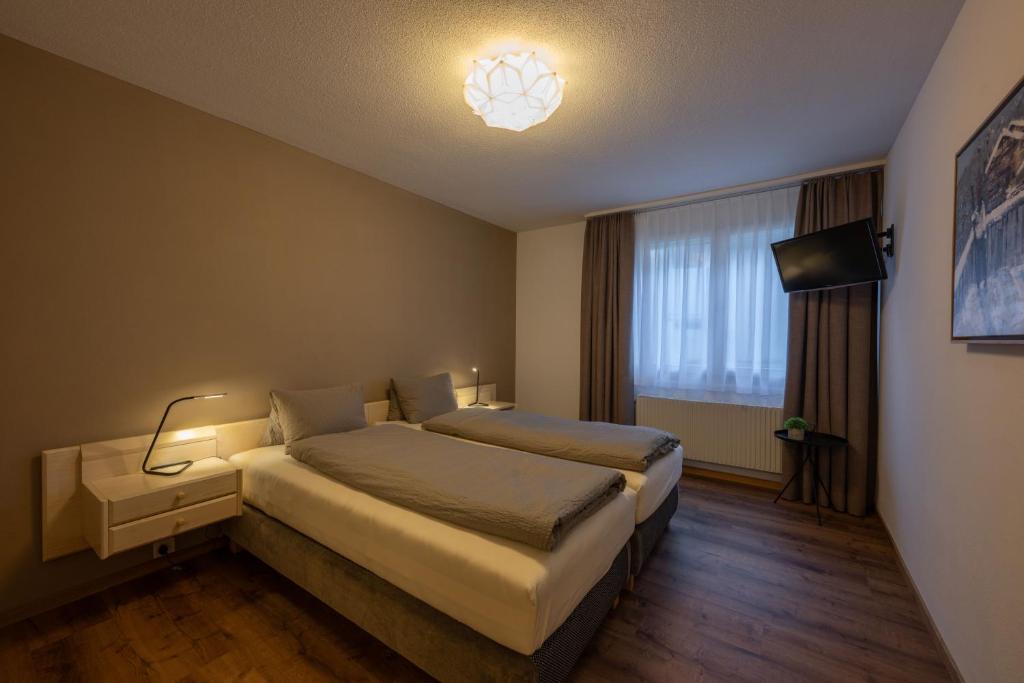 Postel nebo postele na pokoji v ubytování Hotel Alpina