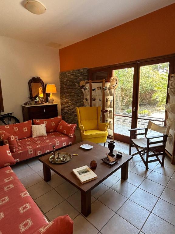 a living room with a couch and a table at Summerhouse Marianna in Ixia