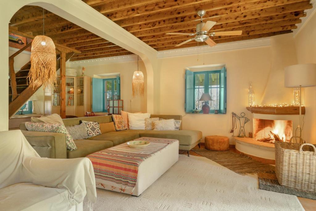 a living room with a couch and a fireplace at Lefkadas Bohemian Cottage in Lefkada Town