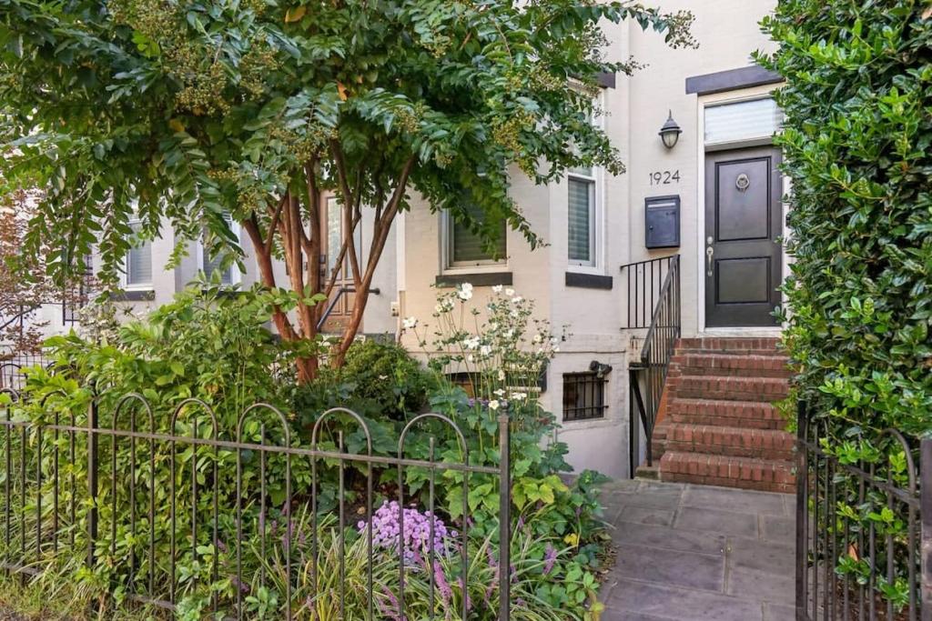 a house with a gate and flowers in front of it at NEW Classy Dupont-Logan Apt Parking in Washington, D.C.