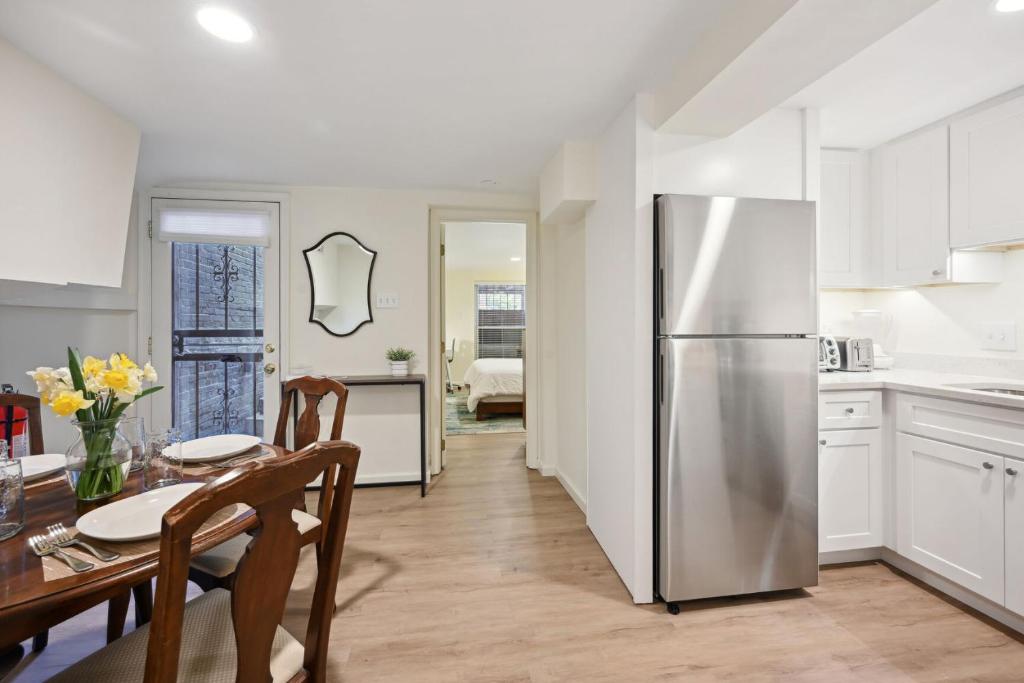 a kitchen and dining room with a stainless steel refrigerator at NEW Classy Dupont-Logan Apt Parking in Washington, D.C.