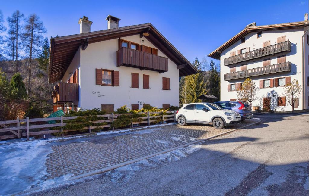 a white car parked in front of a building at Lovely Apartment In San Vito Di Cadore in San Vito di Cadore
