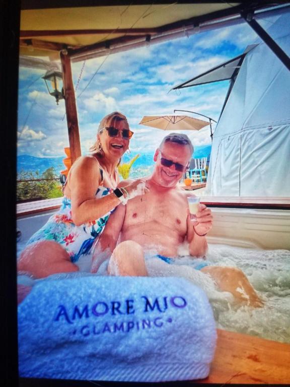 a man and a woman sitting on a boat at Amore Mio Glamping in Jenesano