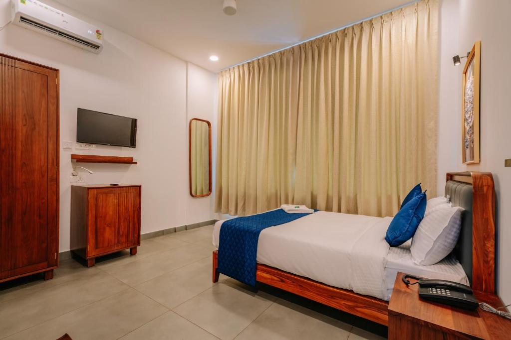 Postel nebo postele na pokoji v ubytování Urbn24 Business Class Hotel