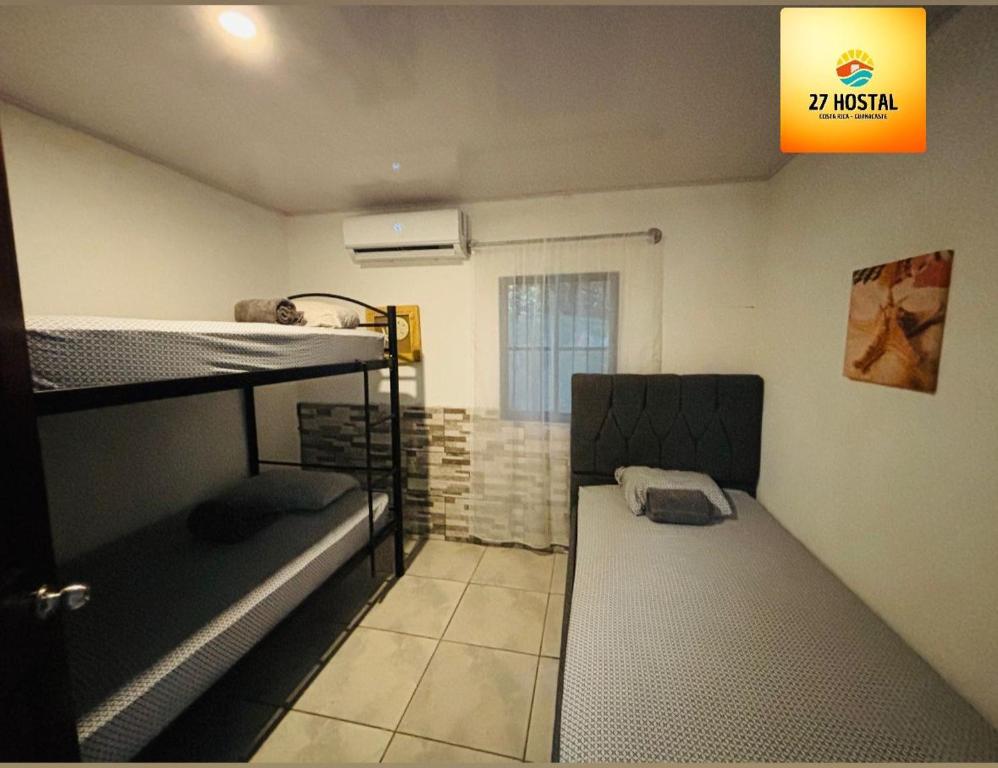 Postel nebo postele na pokoji v ubytování 27 Hostal