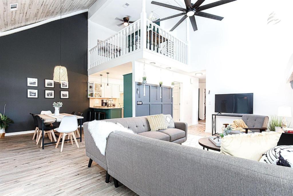 a living room with a couch and a dining room at Scandi Chic-mins to KSU, Sleeps 5, wKing, pet friendly in Kennesaw