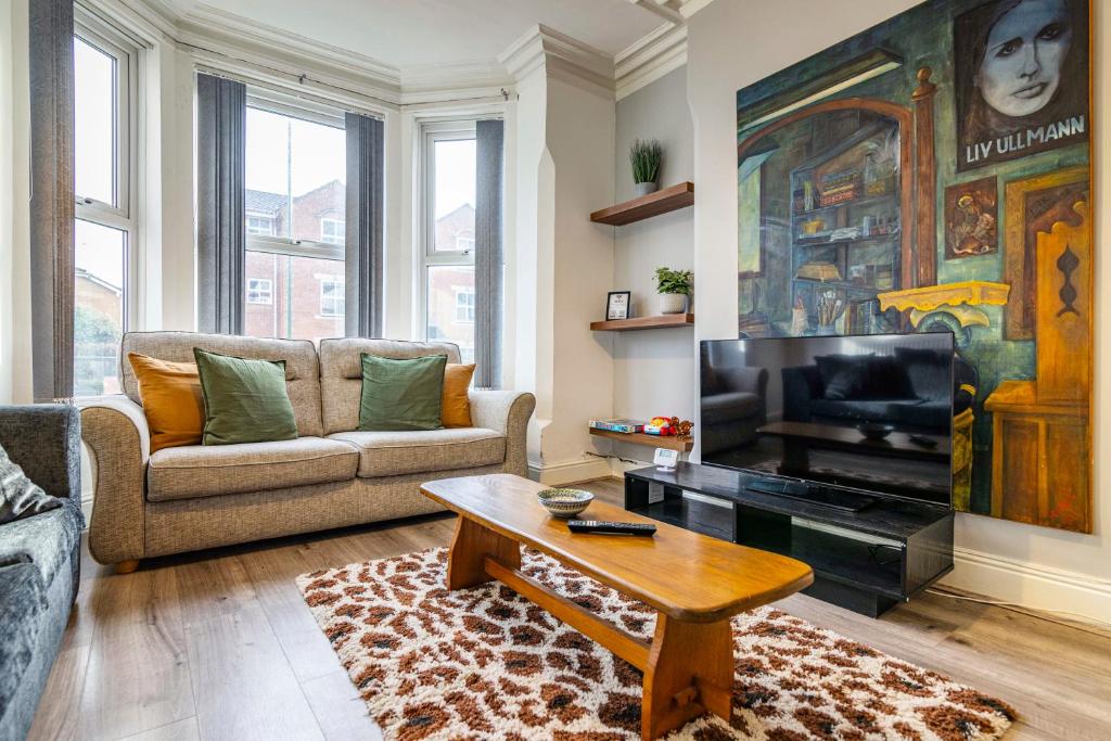 a living room with a couch and a coffee table at Motorpoint Arena House - Sleeps 10 in Nottingham