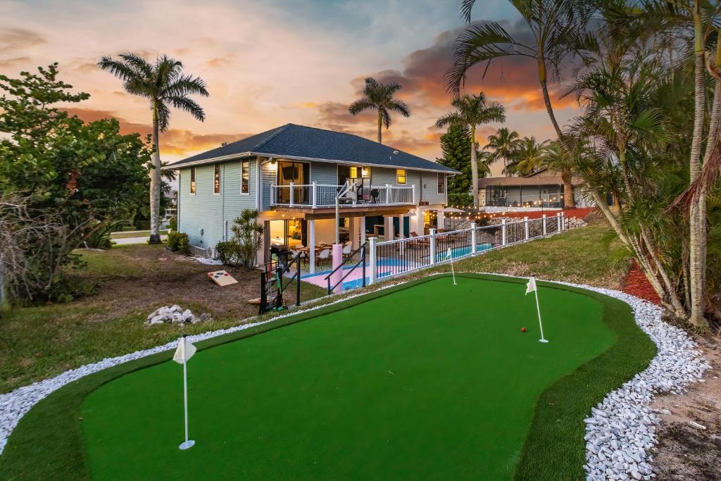 an aerial view of a house with a putting green at Casa Marco - Heated Pool, Game Room, Mini Golf in Marco Island