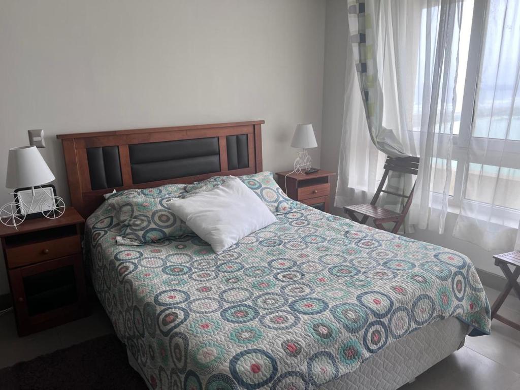 a bedroom with a bed with a pillow on it at LA SERENA- Laguna del Mar in La Serena