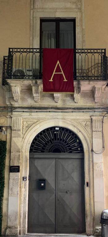 a flag on top of a building with a door at Bellini Luxury Suite Superior in Catania