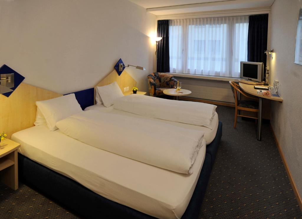 Postel nebo postele na pokoji v ubytování Hotel Blumenstein Self-Check In