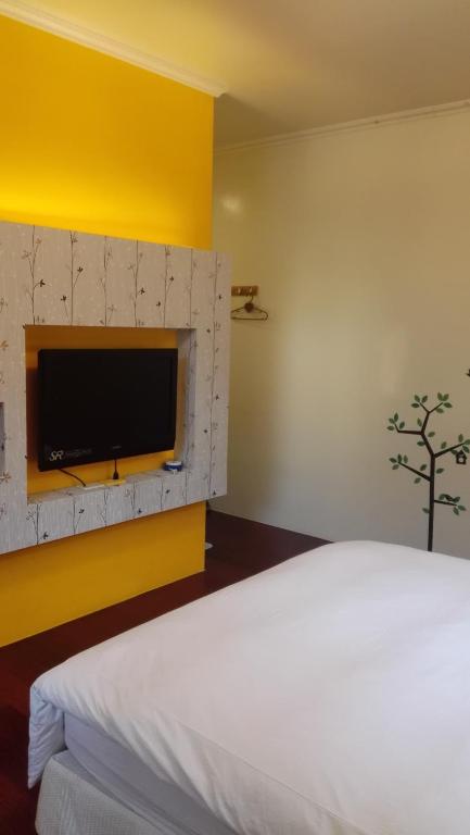 Postel nebo postele na pokoji v ubytování Cocos Hot Spring Hotel