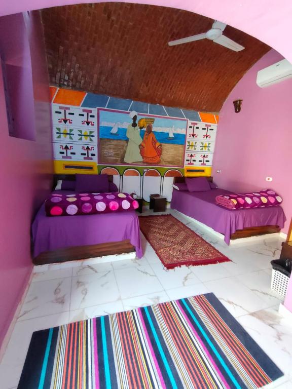 Postel nebo postele na pokoji v ubytování Kamel House