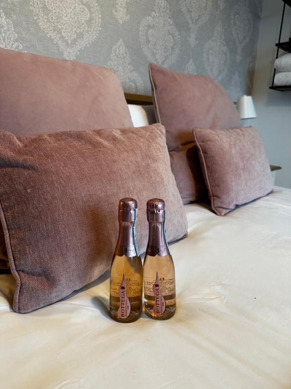 two beer bottles sitting on top of a bed at Malahide Guest Rooms in Malahide