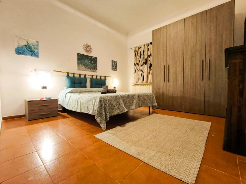 a bedroom with a bed and a wooden cabinet at Karma Rural Buenavista in Santa Marinella