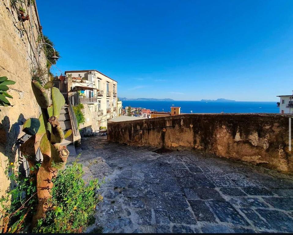 a view of the ocean from an old building at Casa Dolce Casa Luxury in Naples