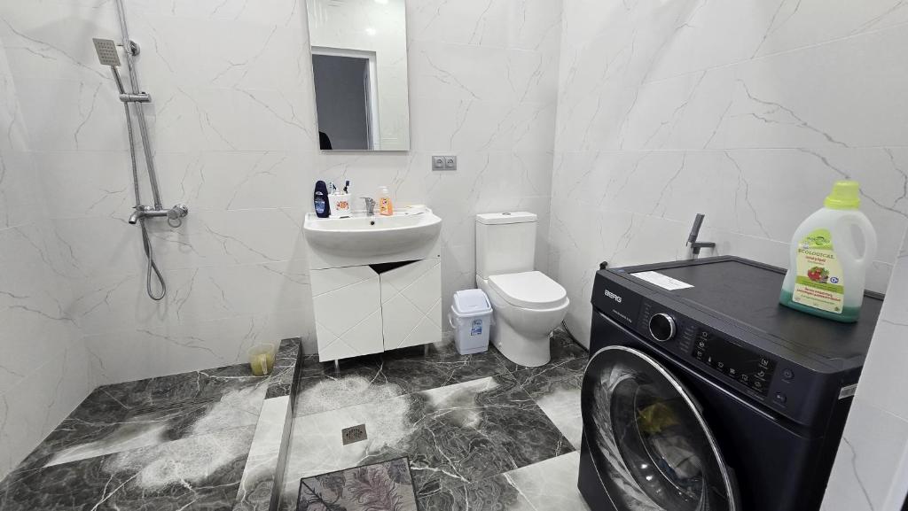 a bathroom with a washing machine and a washer at Райский домик in Lusadzor