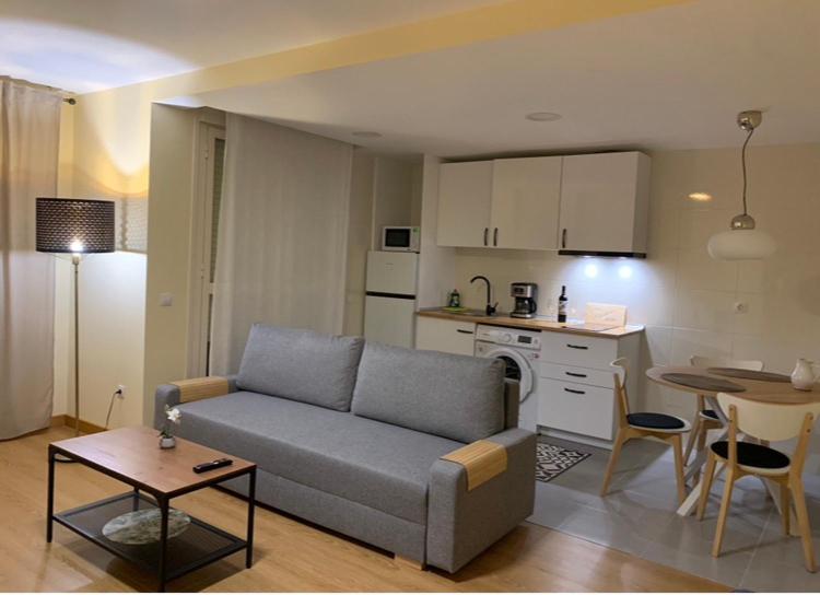 a living room with a couch and a kitchen at Casa Cristina - Rioja II in Cenicero