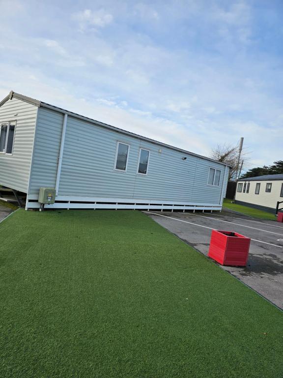 a large blue building with a red box in a parking lot at 34 Brean Leisure Park Unity Beach 6 berth Passes optional No pets in Brean