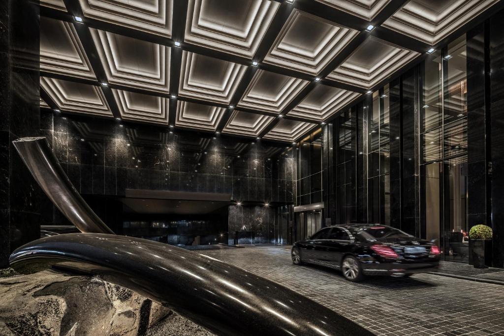a car parked in front of a building at Four Seasons Hotel Seoul in Seoul