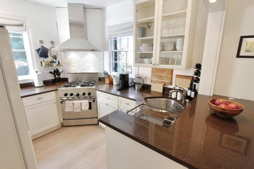a kitchen with white cabinets and a counter top at Idyllic Georgetown in Washington