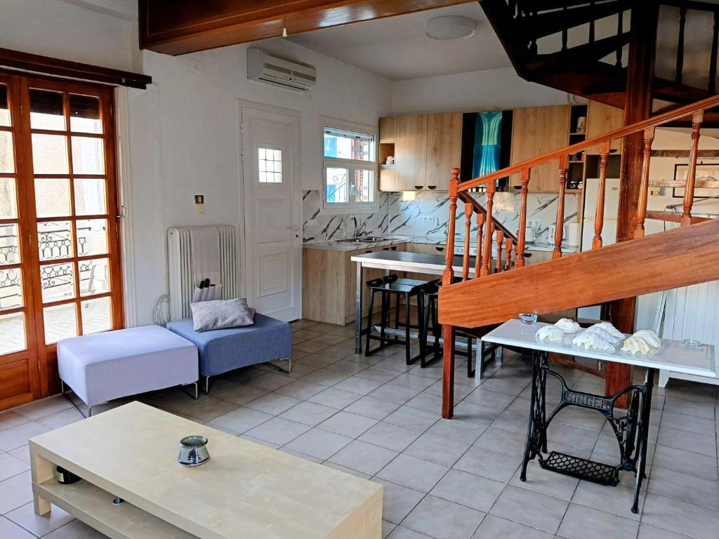 a living room with a staircase and a living room at Holiday House in Porto Heli