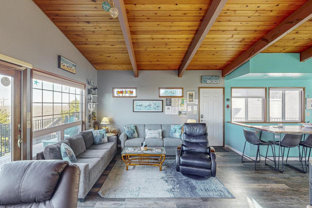 a living room with a couch and a table at Pacific Hideaway in Rockaway Beach