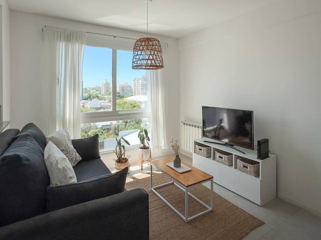 ein Wohnzimmer mit Couch und Flachbildfernseher in der Unterkunft Departamento Rivadavia Centro in Santa Rosa