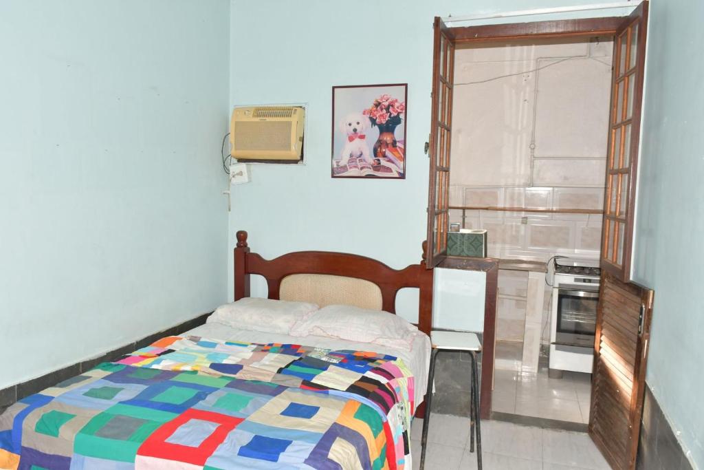 a bedroom with a bed and an open door at Casa com Quarto Duplo com Banheiro Privativo in Rio de Janeiro
