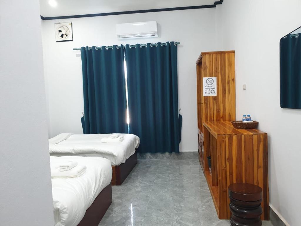 Postel nebo postele na pokoji v ubytování MANYTHIP Hotel