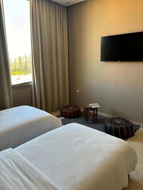 Postel nebo postele na pokoji v ubytování Riad L'Aéroport