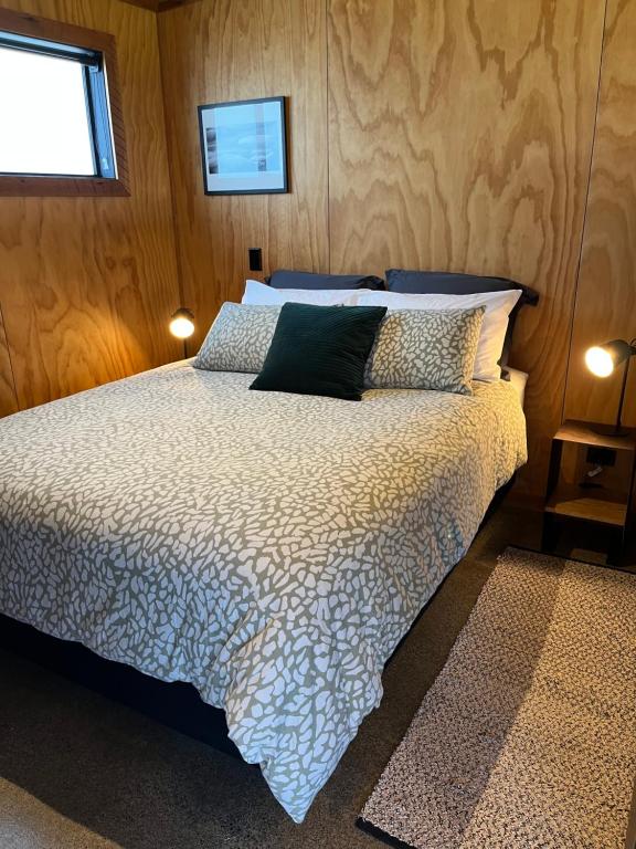 a bedroom with a bed and two pillows on it at Tau Studio - Boutique Accommodation in Ohakune