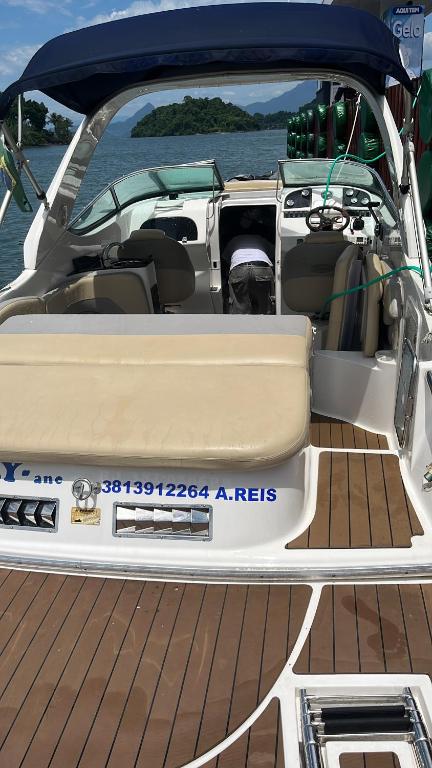 a boat with the back door open on the water at Aluguel de barco em Angra dois reis in Angra dos Reis